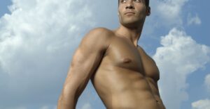 a male with no shirt with the sky in the background with the concept of body sculpting